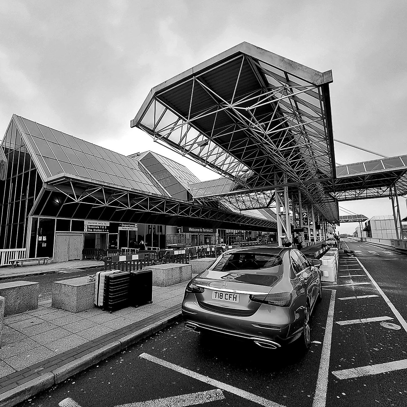 CFH Executive Chauffeurs Mercedes-Benz E-Class waiting at the airport terminal for a client arrival