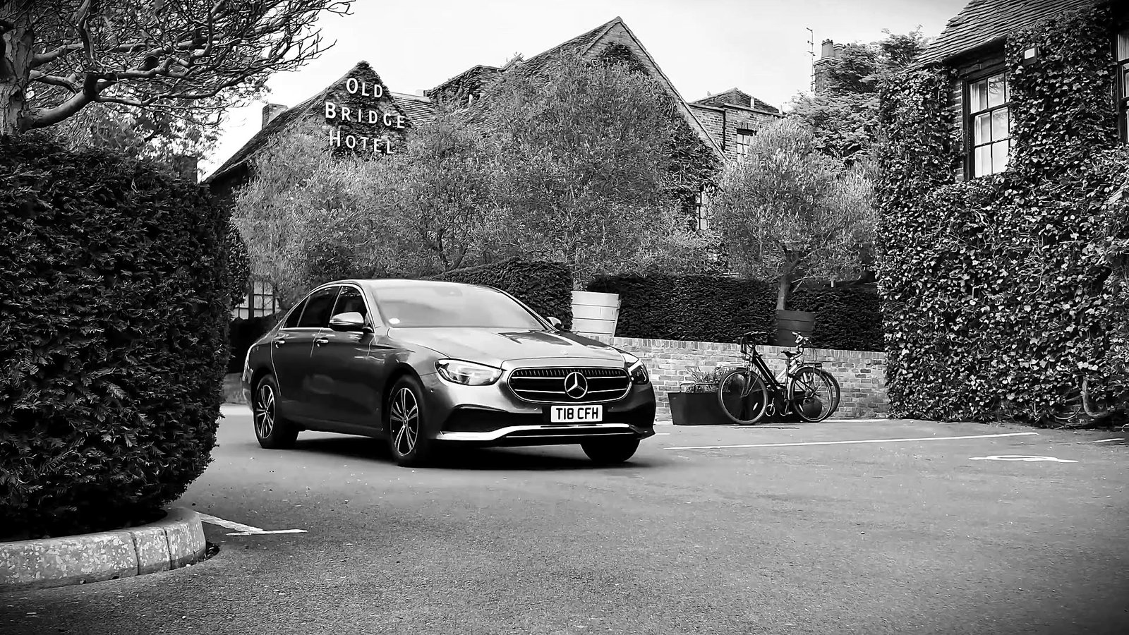 CFH Executive Chauffeurs Mercedes-Benz E-Class Saloon, three-quarter front view outside the Old Bridge Hotel